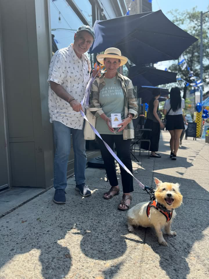 Up Dog Shop giveback program with a rescue dog going home with a new toy
