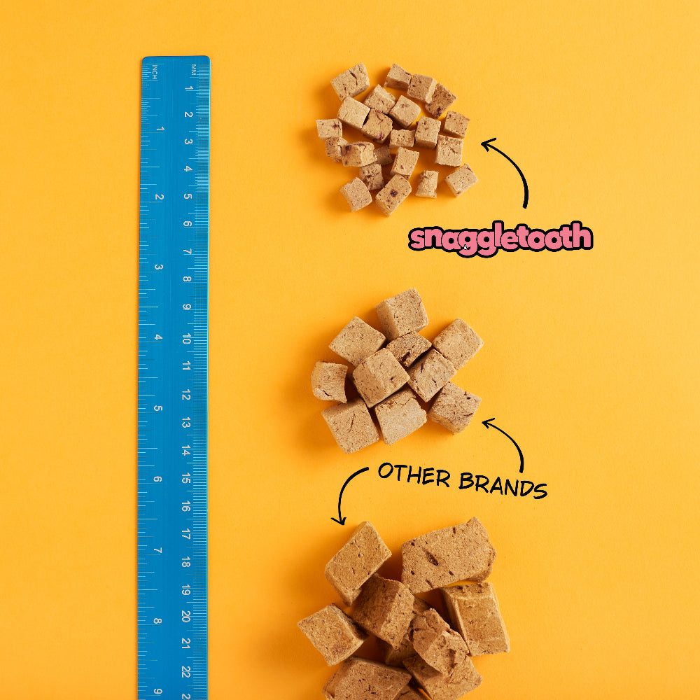 Up Dog X Snaggletooth Special Collab Bundle - Comparison of Snaggletooth dog treats with other brands using a ruler on a yellow background.